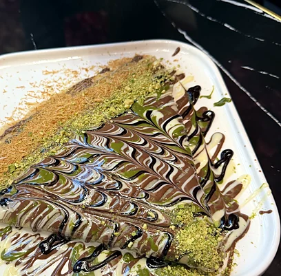 Crepe with pistachio cream and chocolate drizzle