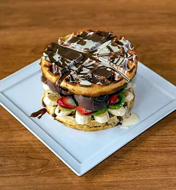 Burger waffle stacked with chocolate and fruit